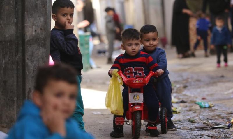 Palestinian children play in an alley at Balata refugee camp on the occasion of Palestinian Children's Day near the West Bank city of Nablus, April 5, 2023. (Photo by Nidal Eshtayeh/Xinhua)