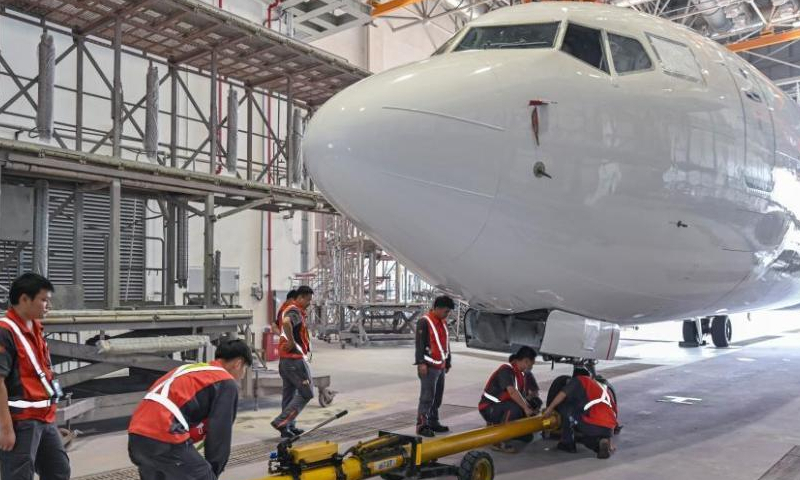 Staff members make preparation work at the painting hangar of the Hainan Free Trade Port One-stop Aircraft Maintenance Industry Base in Haikou, south China's Hainan Province, April 6, 2023. (Photo: China News Service/Luo Yunfei)