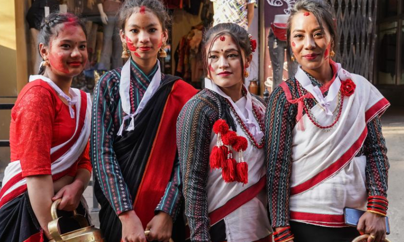 Newar girls in traditional attire pose for photos during a cultural festival in Kathmandu, Nepal, April 9, 2023. (Photo by Hari Maharjan/Xinhua)