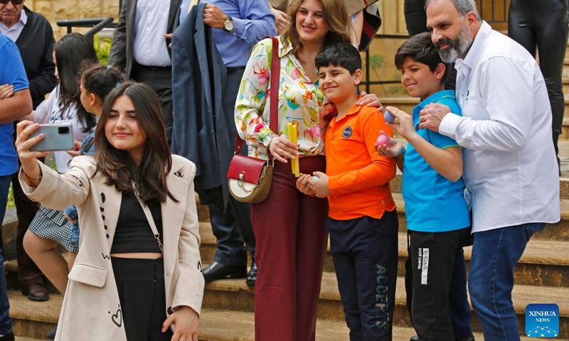 Children pose for photos with Easter eggs in Beirut, Lebanon, April 9, 2023. (Xinhua/Bilal Jawich)