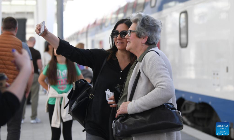 Passengers take a selfie at Novi Sad station in Serbia, May 6, 2023. The 80-kilometer-long, Chinese-built Belgrade-Novi Sad high-speed railway has been carrying passengers at speeds of up to 200 kilometers per hour since March 2022. (Xinhua/Ren Pengfei)