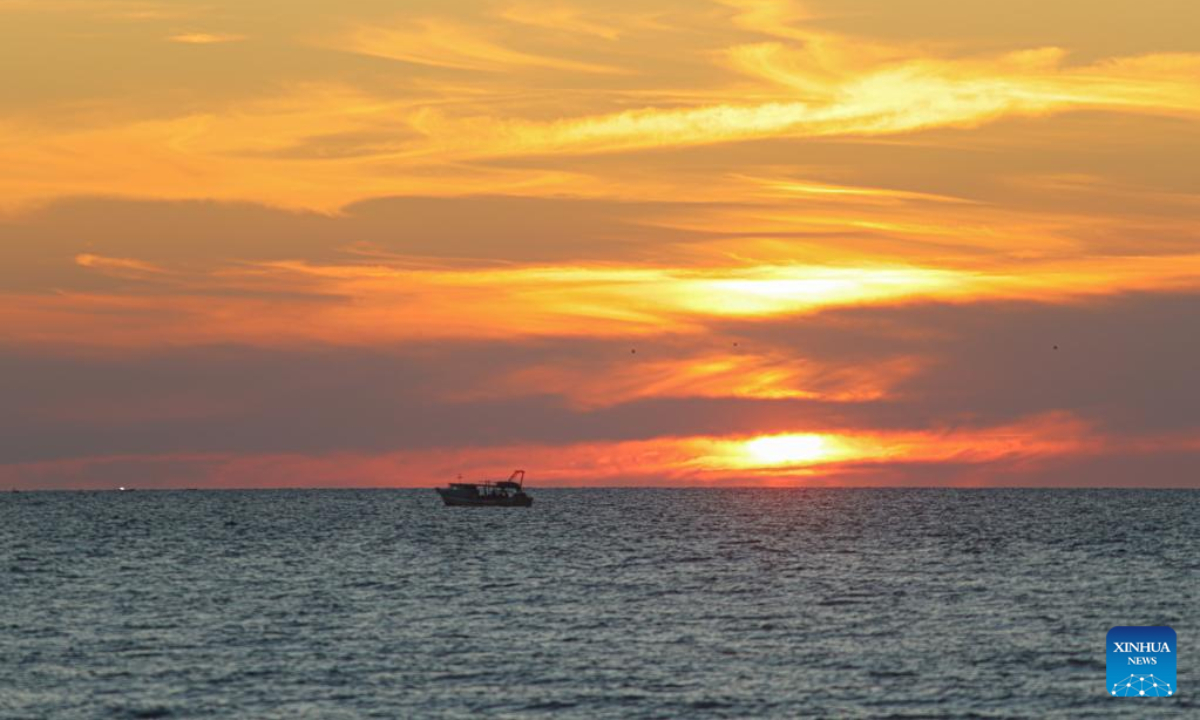 A boat is seen on the Mediterranean Sea at sunset near Gaza City, on April 26, 2023. Photo:Xinhua