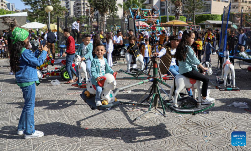 Palestinian children play in a park during the Eid al-Fitr holiday in Gaza City on April 22, 2023. (Photo by Rizek Abdeljawad/Xinhua)