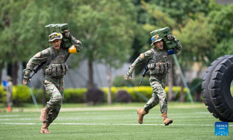 Soldiers of the Chinese People's Liberation Army Garrison stationed in the Macao Special Administrative Region stage military exercises during an open day event at the barracks on Taipa Island in Macao, south China, April 30, 2023. This was the 17th time that the barracks had been opened to the public since 2005, helping with communication between the garrison and local residents. (Xinhua/Cheong Kam Ka)