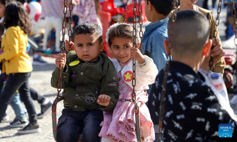 Palestinian children play in a park during the Eid al-Fitr holiday in Gaza City on April 22, 2023. (Photo by Rizek Abdeljawad/Xinhua)