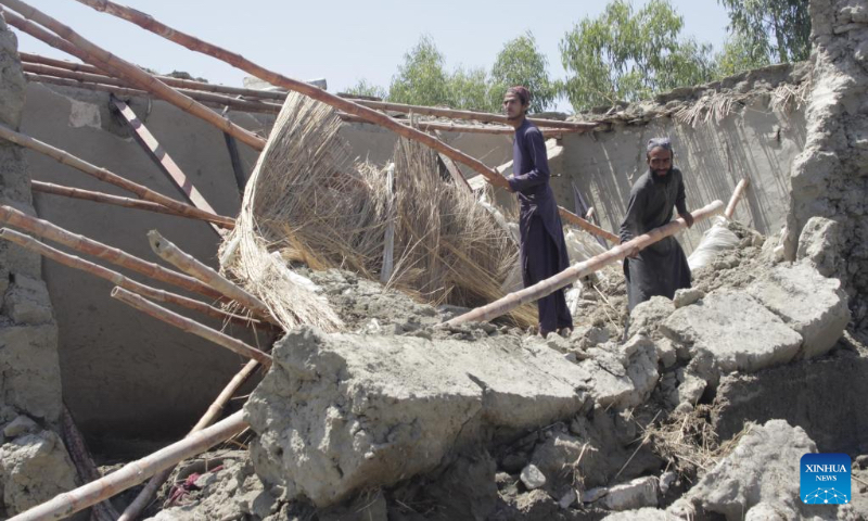 People clear the debris at a flood-affected area in Nangarhar province, Afghanistan, May 6, 2023. Heavy rains and flash floods killed four people and injured 25 others in Afghanistan's eastern Nangarhar province, said a statement of the provincial government released here Saturday. (Photo by Aimal Zahir/Xinhua)