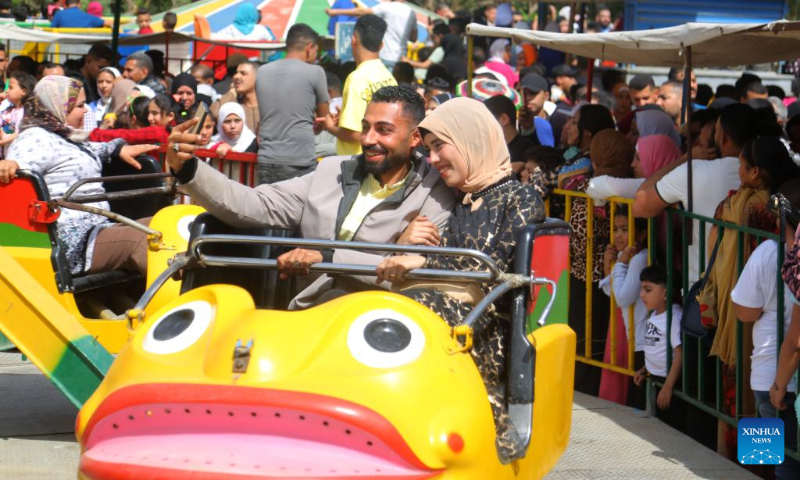 People enjoy themselves at a playground during the Eid al-Fitr holiday in Cairo, Egypt, on April 22, 2023. (Xinhua/Ahmed Gomaa)