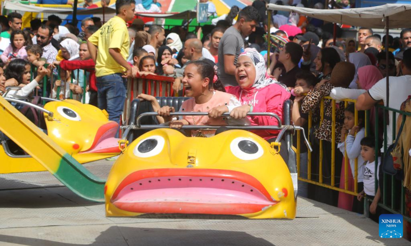 People enjoy themselves at a playground during the Eid al-Fitr holiday in Cairo, Egypt, on April 22, 2023. (Xinhua/Ahmed Gomaa)