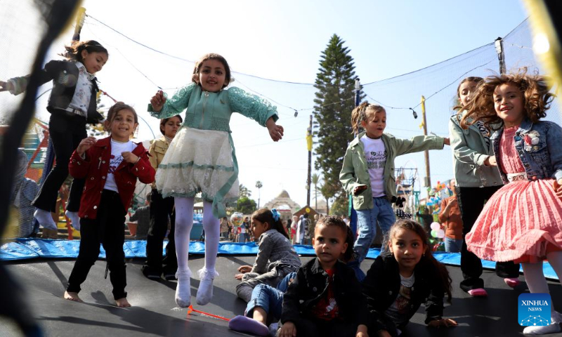 Palestinian children play in a park during the Eid al-Fitr holiday in Gaza City on April 22, 2023. (Photo by Rizek Abdeljawad/Xinhua)