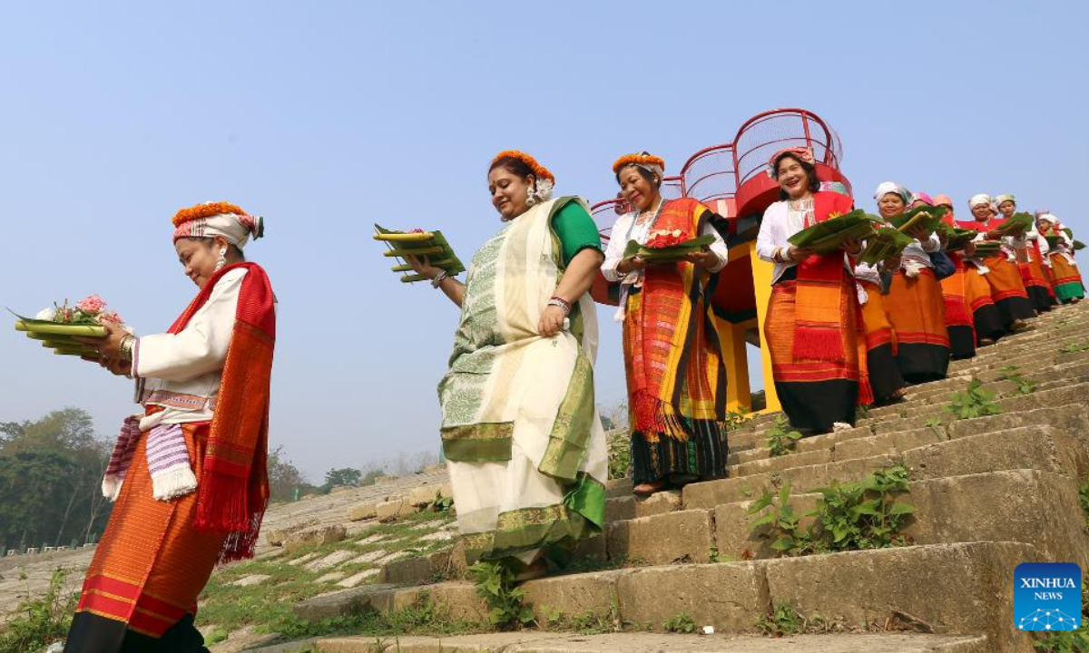 Women wearing traditional dresses and holding flowers are pictured during the celebration of the Boisabi festival in Chattogram, Bangladesh on April 12, 2023. With this festival, indigenous people in Chattogram Hill Tracts region bid farewell to the old year and welcome the new year. Photo:Xinhua