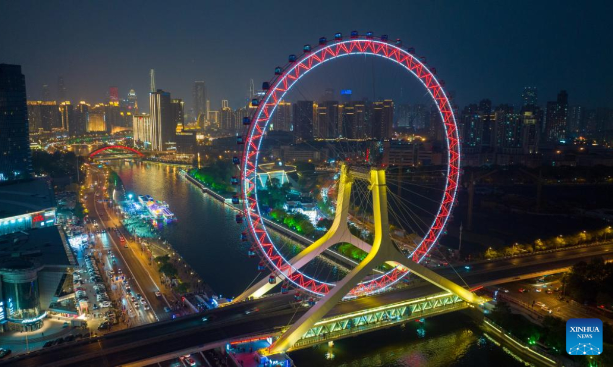 This aerial photo taken on April 27, 2023 shows the night view of Tientsin Eye Ferris wheel in north China's Tianjin. The Tientsin Eye Ferris wheel, also known as the Tianjin Eye, one of the city's landmarks, has been renovated for the upcoming Labor Day holiday. Photo:Xinhua