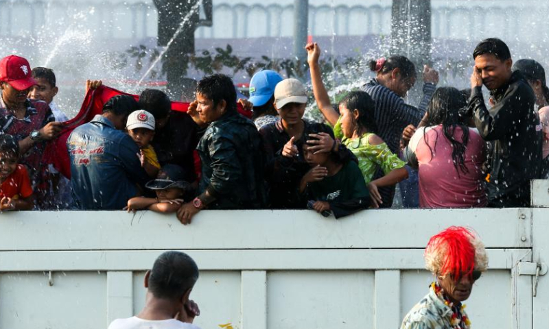 People spray water to celebrate the water festival in Yangon, Myanmar, April 15, 2023. (Photo by Myo Kyaw Soe/Xinhua)