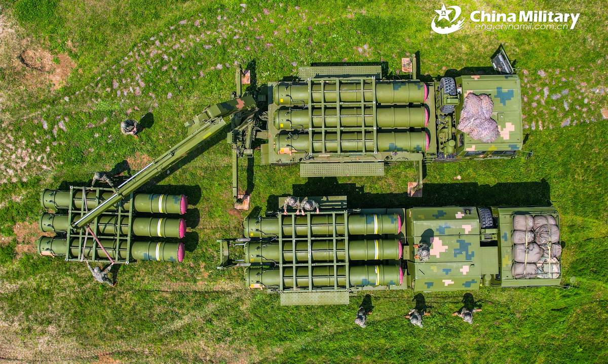 Soldiers assigned to a field training element of a brigade under the PLA 71st Group Army operate a crane to hoist and load air-defense missiles onto the launching truck during a recent operation assessment. (eng.chinamil.com.cn/Photo by Wang Wenzhou)