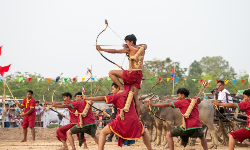 Artists perform archery during the Sankranta festival at the Angkor Archeological Park in Siem Reap province, Cambodia on April 16, 2023. Cambodia kicked off the three-day Sankranta festival, or the Khmer New Year celebration, on Friday. A variety of events, including a cultural show, traditional games, dancing, singing, martial arts, trade exhibition, food show, and modern concert, were held at the festival. (Photo by Sao Khuth/Xinhua)