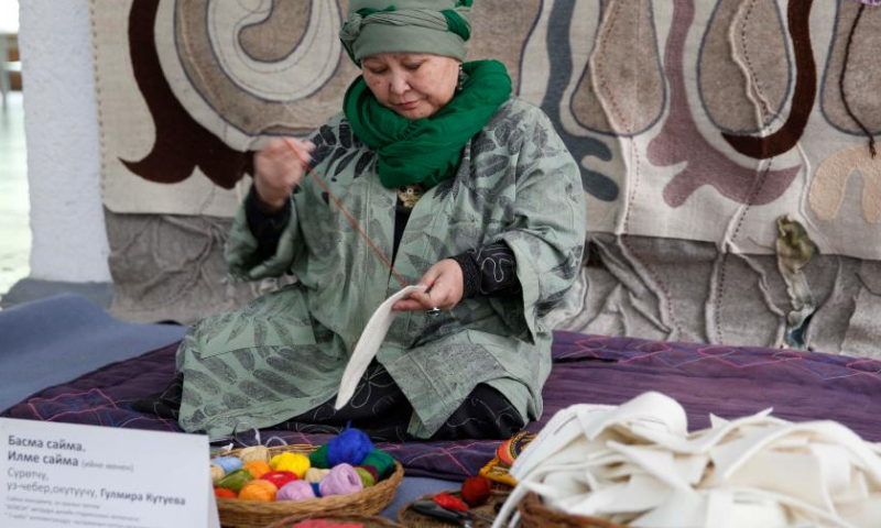 An artisan embroiders at an embroidery festival in Bishkek, Kyrgyzstan, April 15, 2023. An embroidery festival featuring Kyrgyz traditional embroideries was held here on Saturday. (Photo by Roman/Xinhua)