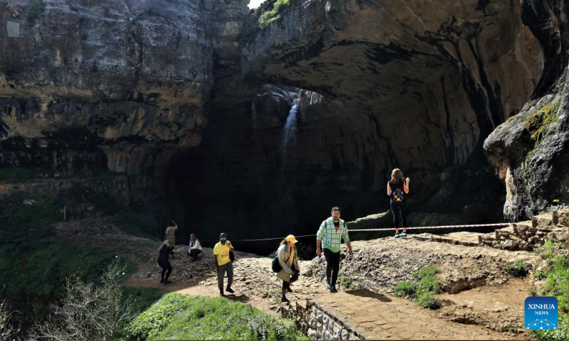 People go hiking in Baatara Pothole in the village of Balaa, Batroun District, Lebanon, April 23, 2023. Baatara Pothole, also known as Balaa Gorge, is located in the village of Balaa in Tannourine of Batroun district in Lebanon. (Xinhua/Liu Zongya)