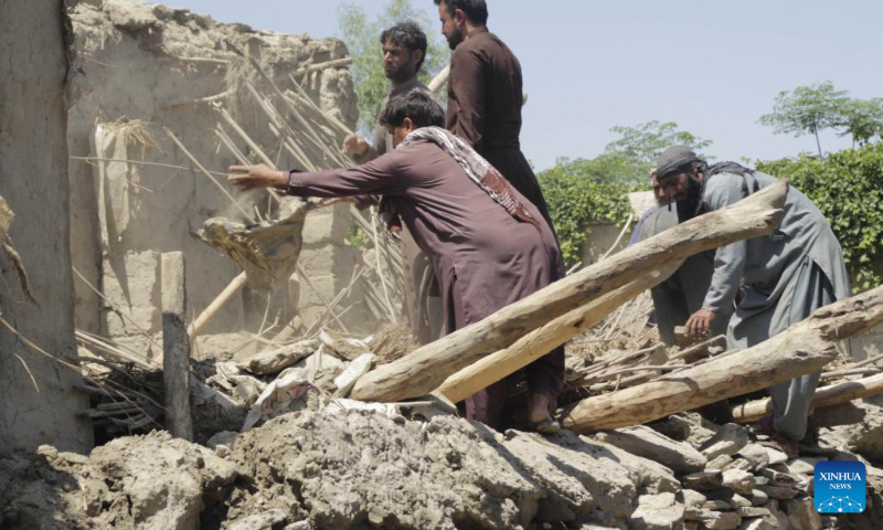 People clear the debris at a flood-affected area in Nangarhar province, Afghanistan, May 6, 2023. Heavy rains and flash floods killed four people and injured 25 others in Afghanistan's eastern Nangarhar province, said a statement of the provincial government released here Saturday. (Photo by Aimal Zahir/Xinhua)