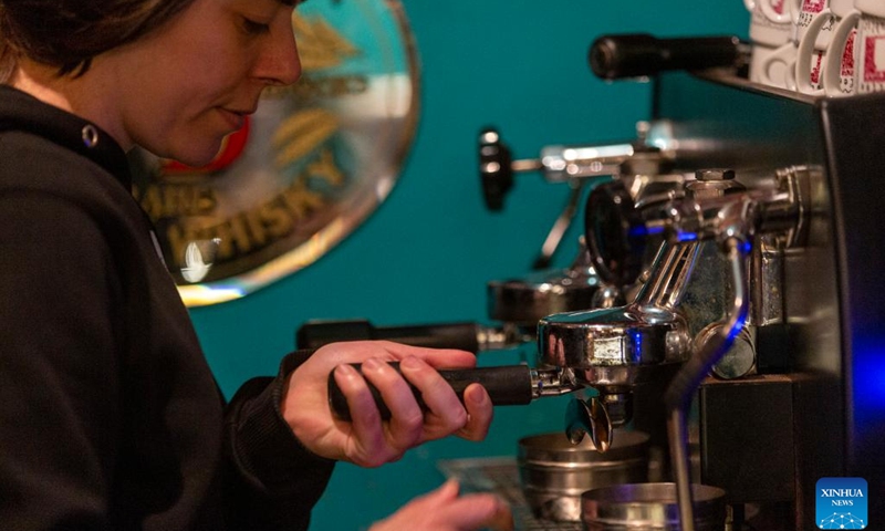 A barista prepares coffee at a local cafe in downtown Athens, Greece, on April 11, 2023. Meeting over a cup of coffee has long been an integral part of Greek culture. However, the inflationary pressure of the past year has forced 54 percent of coffee lovers to cut back on their caffeine habit, a recent survey conducted for the Hellenic Coffee Association has found.(Photo: Xinhua)