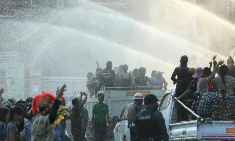 People spray water to celebrate the water festival in Yangon, Myanmar, April 15, 2023. (Photo by Myo Kyaw Soe/Xinhua)