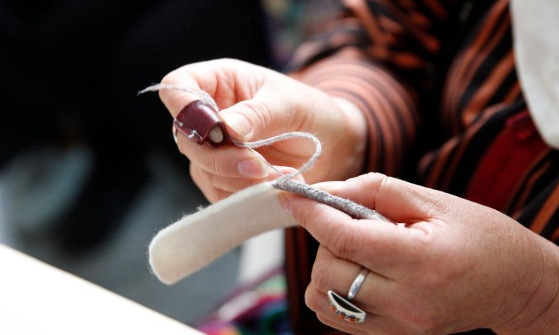 An artisan embroiders at an embroidery festival in Bishkek, Kyrgyzstan, April 15, 2023. An embroidery festival featuring Kyrgyz traditional embroideries was held here on Saturday. (Photo by Roman/Xinhua)