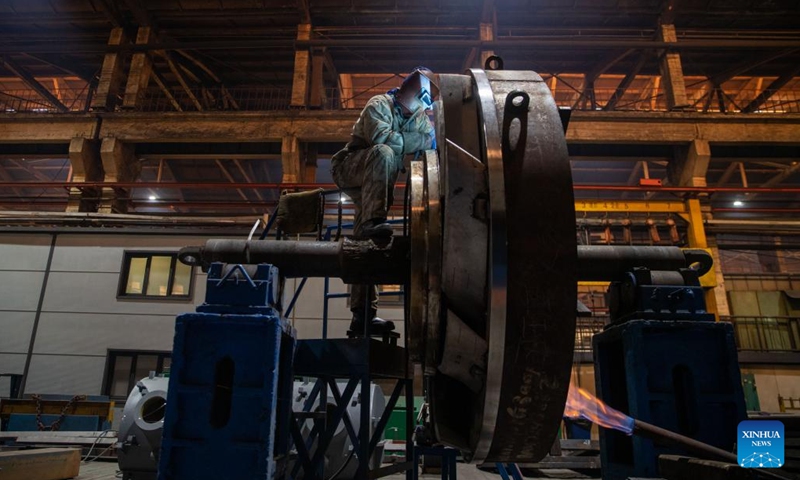 A worker performs production tasks at Harbin Electric Machinery Company Limited of Harbin Electric Corporation in Harbin, capital of northeast China's Heilongjiang Province, April 11, 2023. Harbin Electric Corporation, a veteran state-owned enterprise with a history of over 70 years, has been hailed as the cradle of China's power generation equipment manufacturing industry.(Photo: Xinhua)