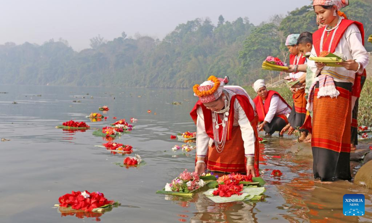 People release floating flowers in a lake to celebrate the Boisabi festival in Chattogram, Bangladesh on April 12, 2023. With this festival, indigenous people in Chattogram Hill Tracts region bid farewell to the old year and welcome the new year. Photo:Xinhua