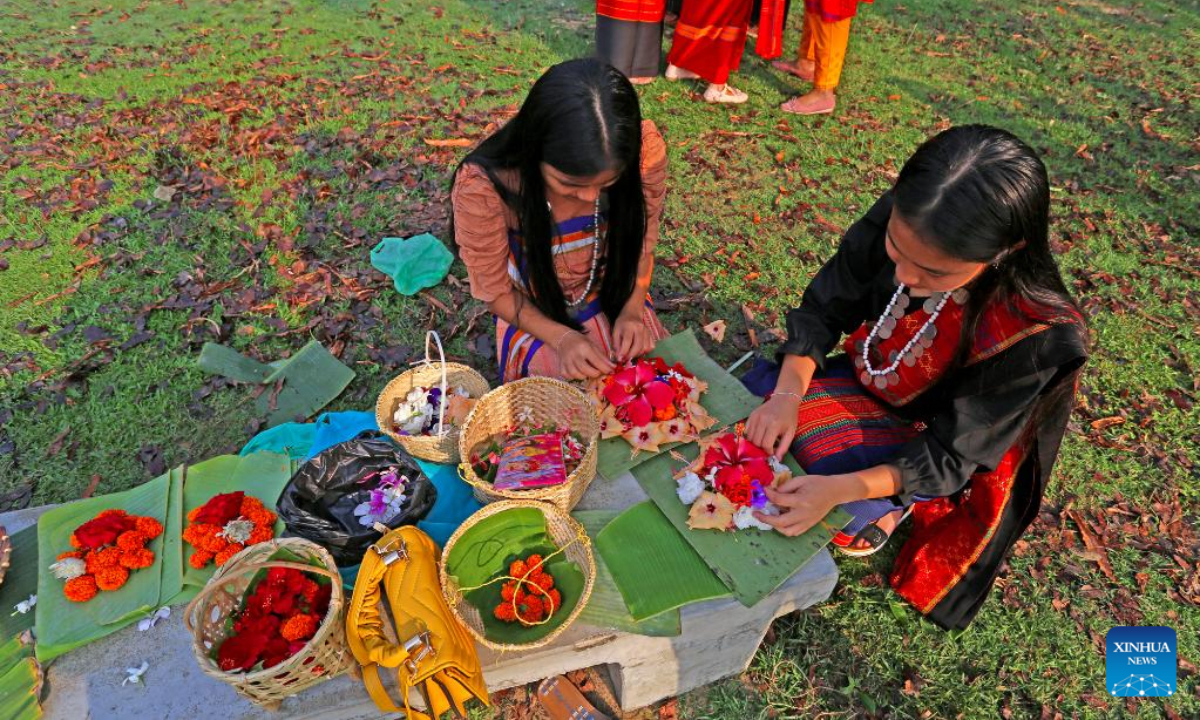 People prepare floating flowers to celebrate the Boisabi festival in Chattogram, Bangladesh on April 12, 2023. With this festival, indigenous people in Chattogram Hill Tracts region bid farewell to the old year and welcome the new year. Photo:Xinhua