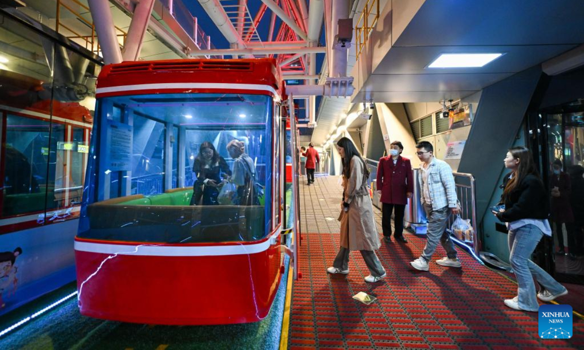 Tourists walk into a gondola car of the Tientsin Eye Ferris wheel, in north China's Tianjin, April 27, 2023. The Tientsin Eye Ferris wheel, also known as the Tianjin Eye, one of the city's landmarks, has been renovated for the upcoming Labor Day holiday. Photo:Xinhua