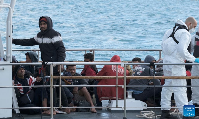 Rescued migrants wait to disembark in Marsaxlokk, Malta, on April 17, 2023. Around 60 migrants were taken to Malta on Monday evening after being rescued from rough seas as they attempted to cross to Europe from Libya.(Photo: Xinhua)