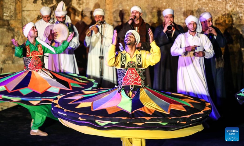 Dancers perform Tanoura, a traditional Egyptian folk dance, during the holy month of Ramadan at the Sultan Al-Ghuri complex in Cairo, Egypt, on April 12, 2023. Tanoura is an Arabic word, which means skirt in English. Tanoura dance is a traditional folk dance in Egypt, where the dancer in colorful skirts spins to the tunes of songs.(Photo: Xinhua)