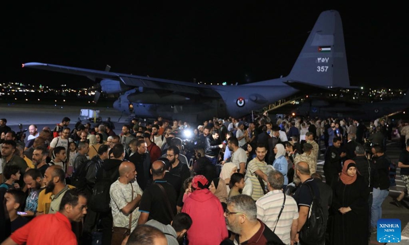 People evacuated from Sudan arrive at Marka Military Airport in Amman, Jordan, on April 24, 2023. Jordan evacuated 343 people from Sudan on Monday, the state-run Petra news agency reported. A total of 343 Jordanians, Palestinians, Iraqis, Syrians and Germans arrived in Jordan early Monday in four planes of the Royal Jordanian Air Forces, said the report.(Photo: Xinhua)