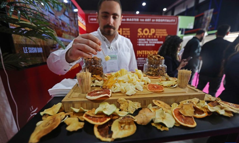 An exhibitor works at a stand at the HORECA Lebanon in Beirut, Lebanon, on April 25, 2023. About 160 Lebanese and international exhibitors attended the HORECA Lebanon, an annual trade fair for the hospitality industry, which kicked off here on Tuesday.(Photo: Xinhua)