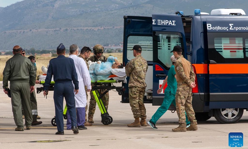 A wounded man evacuated from Sudan is transferred to an ambulance at the military airfield of Elefsina near Athens, Greece, on April 25, 2023. Greece has evacuated over 50 of its citizens and their family members from the Sudanese capital Khartoum amid military clashes, Greek Foreign Affairs Minister Nikos Dendias said on Tuesday.(Photo: Xinhua)