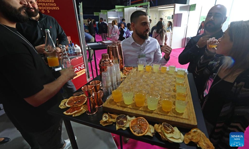 People taste juice at the HORECA Lebanon in Beirut, Lebanon, on April 25, 2023. About 160 Lebanese and international exhibitors attended the HORECA Lebanon, an annual trade fair for the hospitality industry, which kicked off here on Tuesday(Photo: Xinhua)