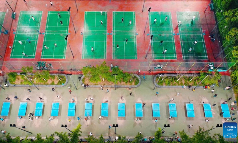 This aerial photo taken on April 30, 2023 shows people exercising at a sports center during the May Day holiday in southwest China's Chongqing. (Photo by Liu Hui/Xinhua)