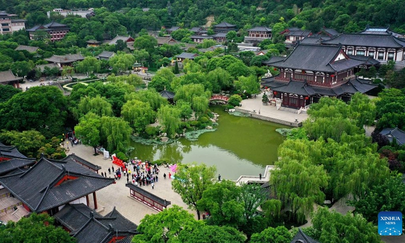 This aerial photo shows tourists visiting the Huaqing Palace scenic area in Xi'an, northwest China's Shaanxi Province, May 5, 2023. Xi'an, a city with over 3,100 years of history, served as the capital for 13 dynasties in Chinese history. It is also home to the world-renowned Terracotta warriors created in the Qin Dynasty (221-207 BC).(Photo: Xinhua)