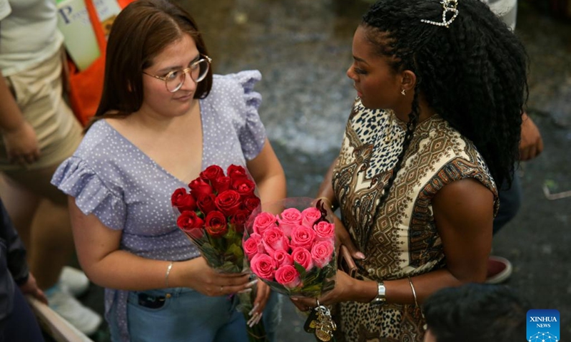 Two women are seen with flowers in Mexico City, Mexico, May 9, 2023. Mother's Day in Mexico is celebrated on May 10.(Photo: Xinhua)