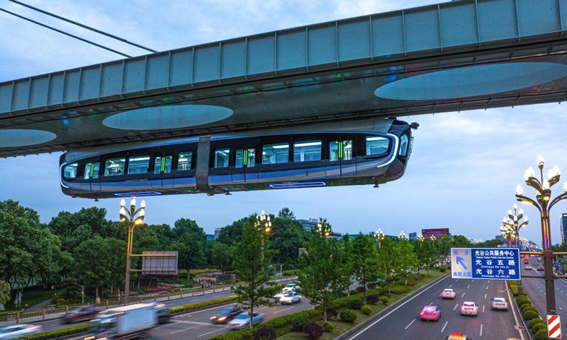 This aerial photo taken on May 9, 2023 shows a train running on the suspension monorail line in Wuhan, central China's Hubei Province. The suspension monorail line in Wuhan has undergone a running test before being put into trial operation.(Photo: Xinhua)