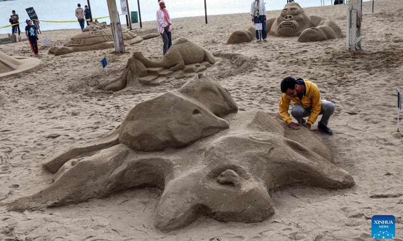 An artist works on a sand sculpture during a sand sculpture festival in Alexandria, Egypt, on May 10, 2023. The four-day Alexandria Sand Sculpture Festival, the first of its kind held by Alexandria governorate to promote tourism and encourage young talents, concluded on Wednesday evening.(Photo: Xinhua)