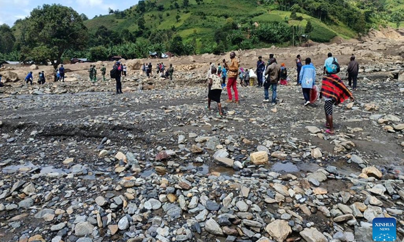 People gather at an area hit by flooding and landslides in Kalehe, South Kivu Province, the Democratic Republic of the Congo (DRC), on May 9, 2023. Flooding and landslides brought by torrential rains in the eastern Democratic Republic of the Congo (DRC) have killed 438 villagers, local media reported Thursday, citing a government spokesperson.(Photo: Xinhua)