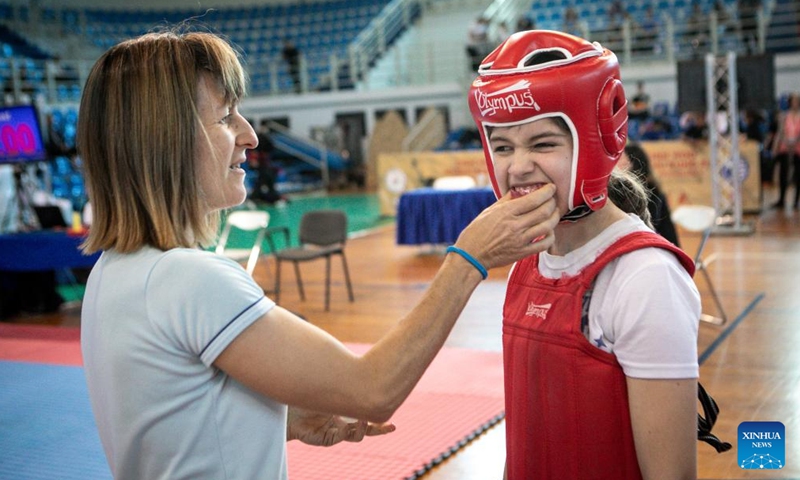 A young practitioner of Sanda, a style of competitive Wushu, prepares to compete during the 1st European Chin Woo Wushu Kung Fu Open Championship and Chinese Cultural Festival in Athens, Greece on May 27, 2023.

The event kicked off on Saturday in Athens, offering a taste of Chinese culture to local audiences. (Photo by Panagiotis Moschandreou/Xinhua)