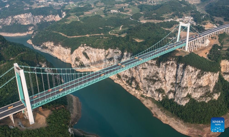 This aerial photo taken on May 21, 2023 shows the Jinfeng Wujiang River Bridge under static load testing in southwest China's Guizhou Province. Static load testing, including symmetrical and asymmetrical rounds, were conducted on the bridge Sunday. The bridge, which is 1473.5 meters in length, is a main project on the Guiyang-Jinsha-Gulin expressway. (Xinhua/Tao Liang)