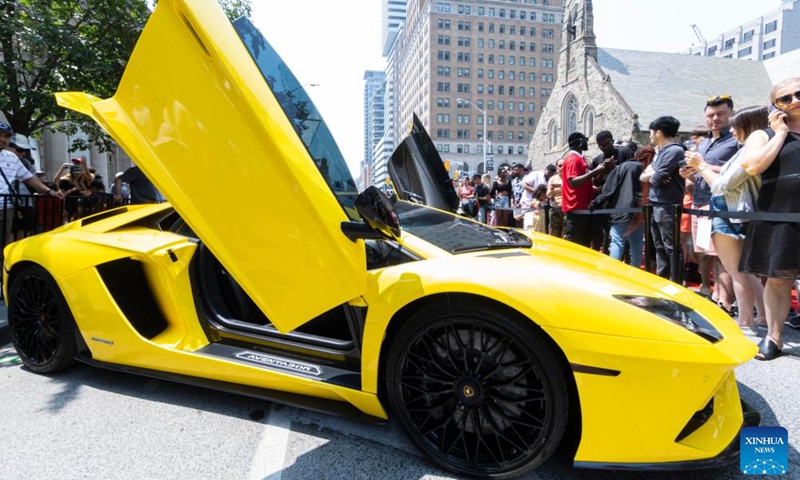 People visit the 2023 Yorkville Exotic Car Show in Toronto, Canada, on June 18, 2023. The annual event was held here on Sunday to celebrate Father's Day with about 100 cars on display. (Photo by Zou Zheng/Xinhua)