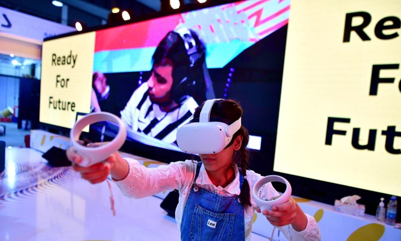 A girl wearing a VR headset is seen at an exhibition of technologies in Damascus, Syria, on June 10, 2023. (Photo by Ammar Safarjalani/Xinhua)