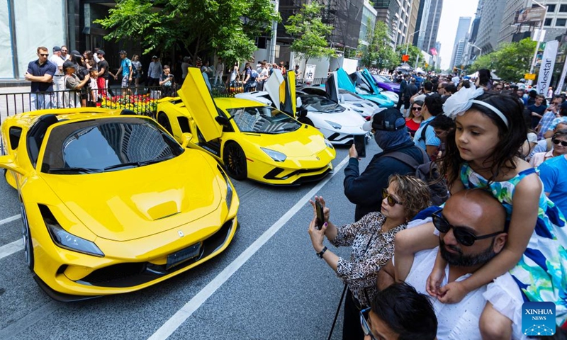 People visit the 2023 Yorkville Exotic Car Show in Toronto, Canada, on June 18, 2023. The annual event was held here on Sunday to celebrate Father's Day with about 100 cars on display. (Photo by Zou Zheng/Xinhua)