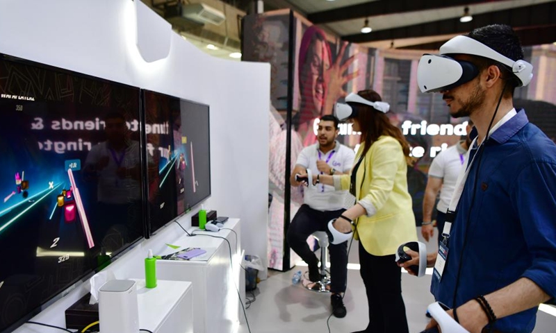 People wearing VR headsets are seen at an exhibition of technologies in Damascus, Syria, on June 10, 2023. (Photo by Ammar Safarjalani/Xinhua)