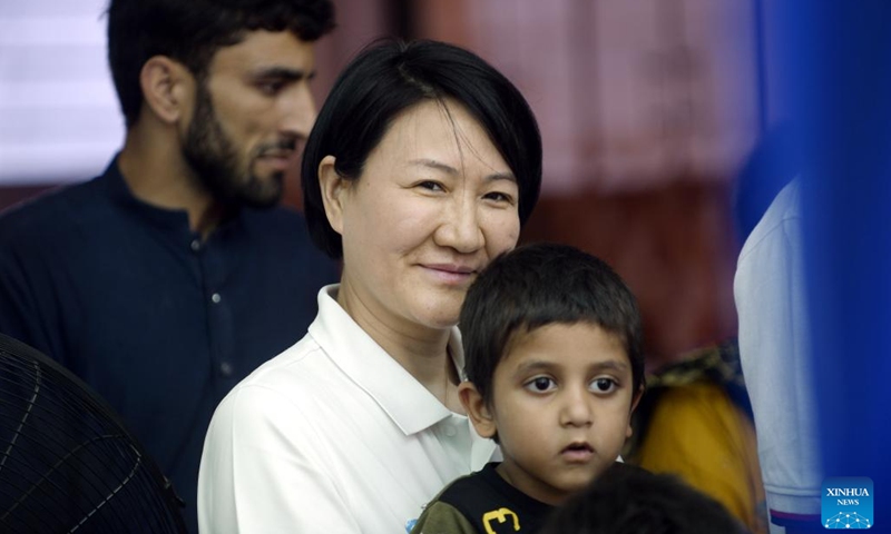 A Chinese volunteer takes care of a child at the China-funded compassionate home in Islamabad, Pakistan, May 28, 2023. A compassionate home formed by Chinese and Pakistani charity organizations was formally inaugurated here on Sunday to provide temporary accommodation for the relatives of children treated in hospitals for serious diseases(Photo: Xinhua)