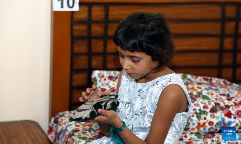 A girl plays with her toy at the China-funded compassionate home in Islamabad, Pakistan, May 28, 2023. A compassionate home formed by Chinese and Pakistani charity organizations was formally inaugurated here on Sunday to provide temporary accommodation for the relatives of children treated in hospitals for serious diseases.(Photo: Xinhua)