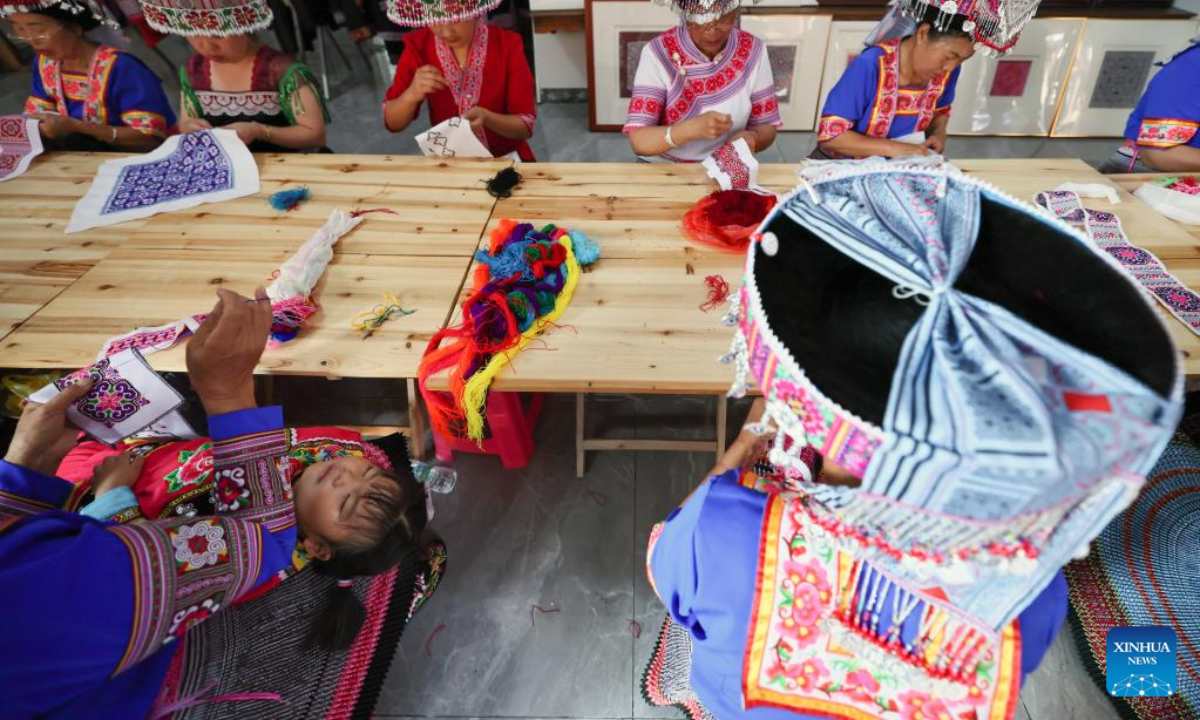 Women of Miao ethnic group make embroidery works at a workshop in Pingbian Miao Autonomous County, southwest China's Yunnan Province, June 1, 2023. Pingbian Miao Autonomous County has been making efforts to support and develop its embroidery industry, trying to provide job opportunities to local women. Photo:Xinhua