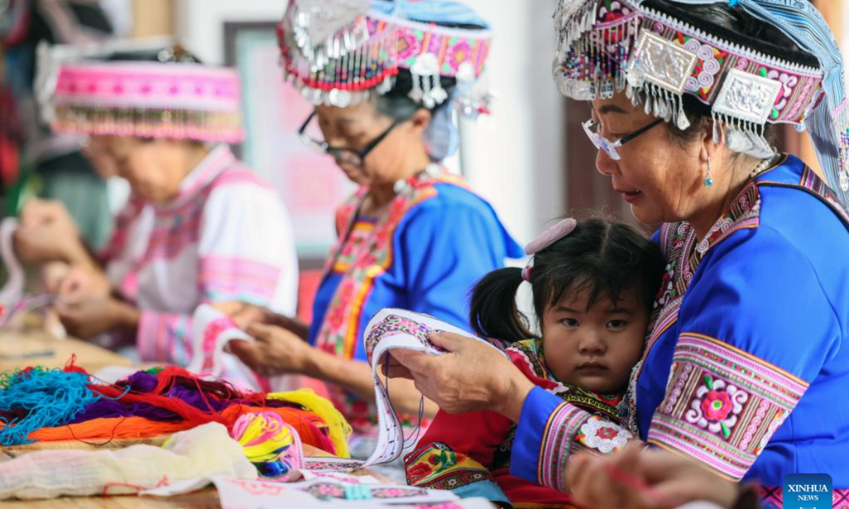 Women of Miao ethnic group make embroidery works at a workshop in Pingbian Miao Autonomous County, southwest China's Yunnan Province, June 1, 2023. Pingbian Miao Autonomous County has been making efforts to support and develop its embroidery industry, trying to provide job opportunities to local women. Photo:Xinhua